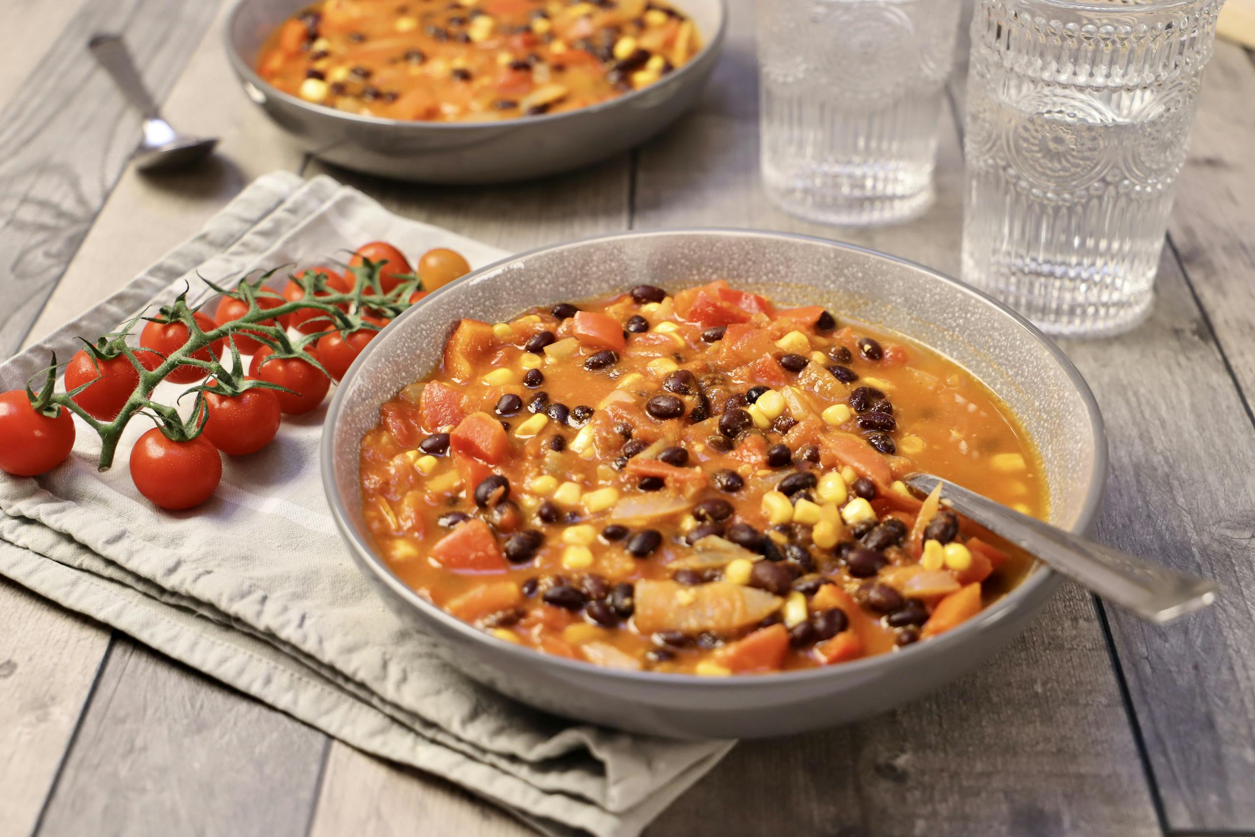 Warm and hearty vegetable bean stew served in rustic bowls, perfect for a cozy meal.